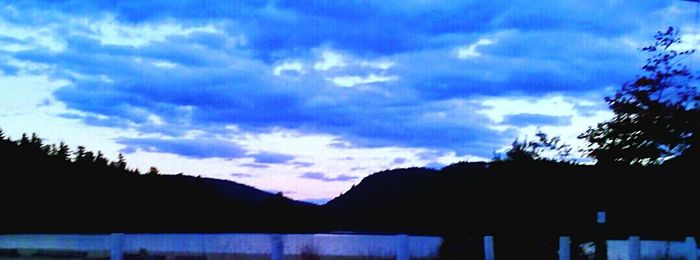 Scenic view of mountains against cloudy sky