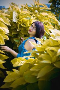 Portrait of smiling woman with yellow flower