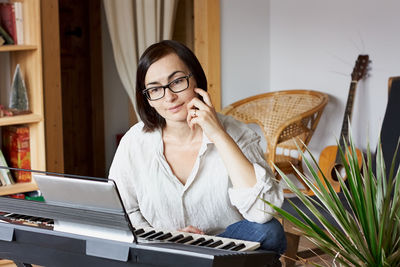 Young woman using mobile phone at home