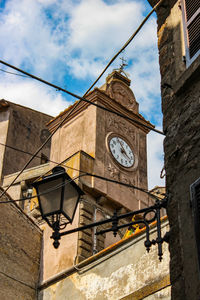 Low angle view of clock tower against sky in city