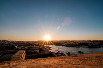 Scenic view of sea against clear sky during sunset