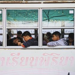 Portrait of people sitting in glass window