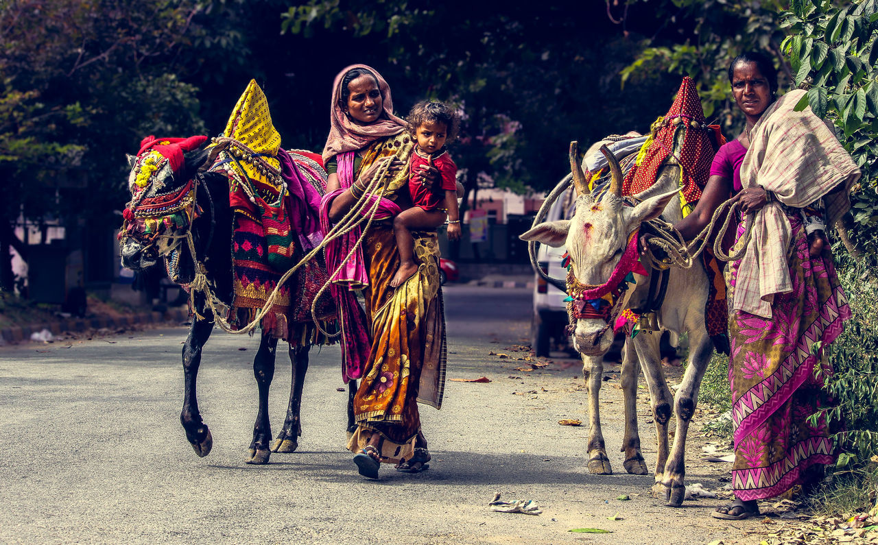 PEOPLE IN TRADITIONAL CLOTHING OUTDOORS