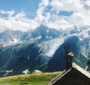 Statue on mountain against sky