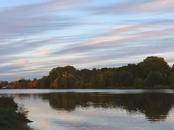 Scenic view of lake against sky at sunset