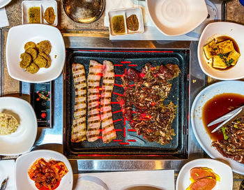 Korean barbecue feast of pork belly, beef bulgogi, and banchan 