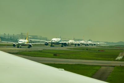 Airplane on runway against sky