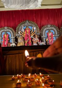 View of lit candles in temple