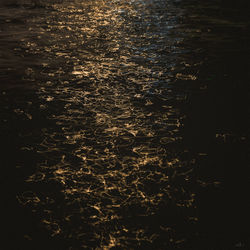 High angle view of illuminated sea against sky at night