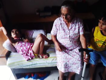 Rear view of two women sitting at home