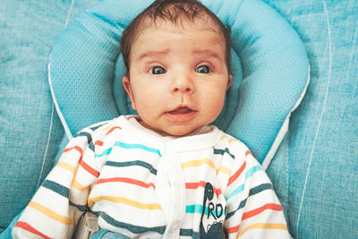 Cute baby girl on bed at home