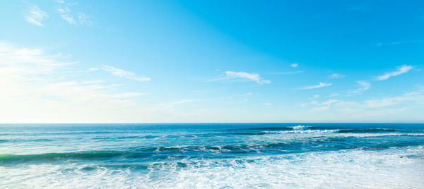 Scenic view of sea against blue sky