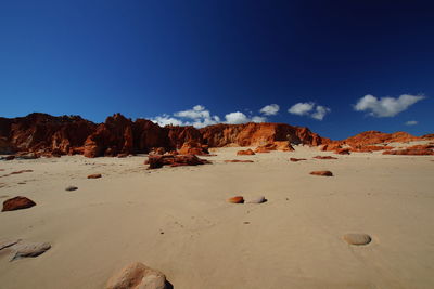 Rock formations in desert against blue sky