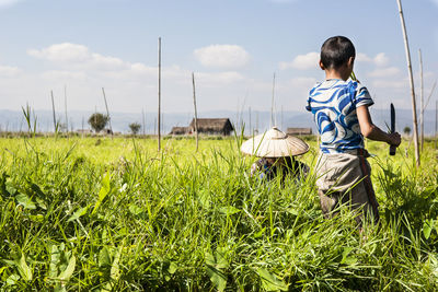 People walking on grassy field