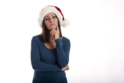 Portrait of young woman looking away against white background