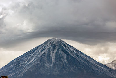 View of snowcapped mountain against cloudy sky