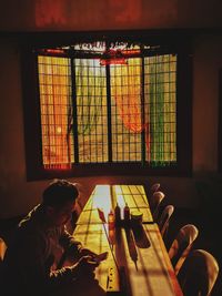 Man using mobile phone on table at home