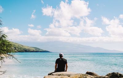 Rear view of man looking at sea