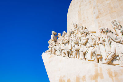 Low angle view of statue against clear blue sky