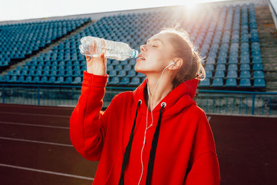 Young woman drinking water from bottle