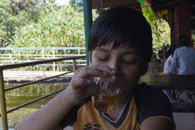 Portrait of girl drinking glass at restaurant