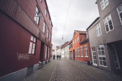 Street amidst buildings against sky in city