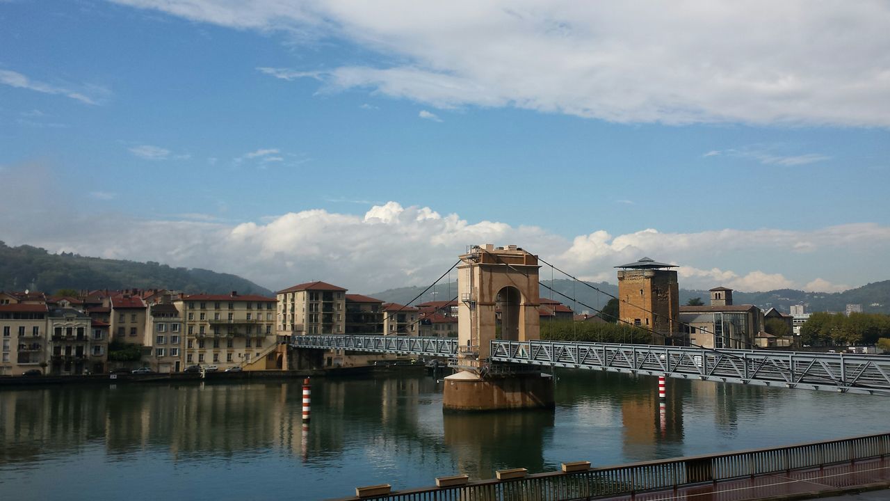 architecture, building exterior, built structure, water, sky, city, river, cityscape, residential building, cloud - sky, residential structure, waterfront, residential district, cloud, building, city life, day, cloudy, bridge - man made structure, reflection