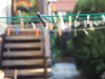 Close-up of clothespins hanging on clothesline