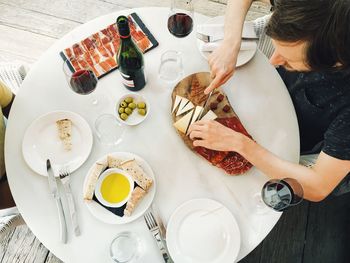 Overhead view of man preparing food at table