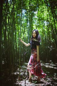 Portrait of young woman in forest