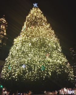 Low angle view of illuminated christmas tree at night