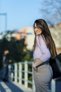 Smiling woman standing in city