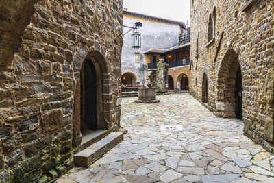 Alley amidst buildings against wall