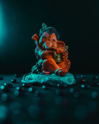 Close-up of illuminated decoration on table against black background