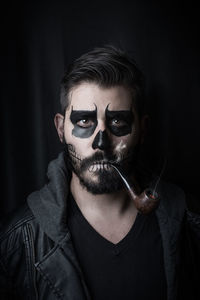 Close-up portrait of man smoking pipe