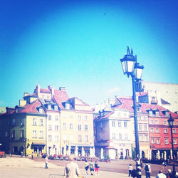 Buildings in city against blue sky