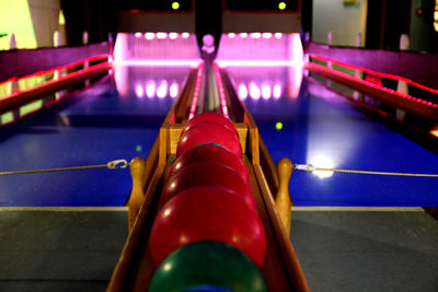 Colorful bowling balls on rack at alley