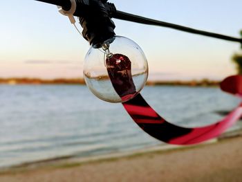 Close-up of water drop hanging on beach