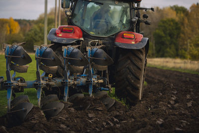 Tractor plowing field at autumn