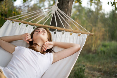 Woman lying on hammock