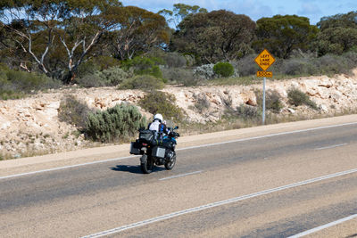 Man riding motorcycle on road