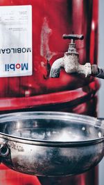 Close-up of water faucet in container