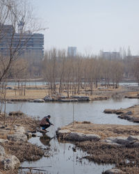 Scenic view of lake against sky during winter