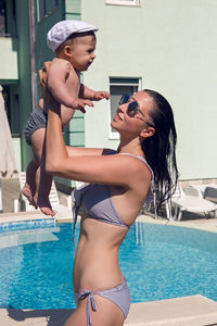 Mother and son sitting near the pool at the resort