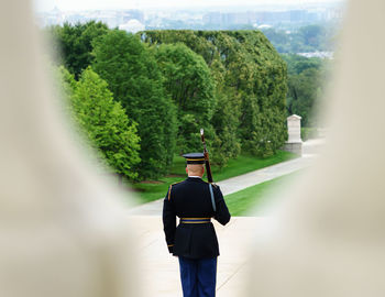 Rear view of man standing by trees