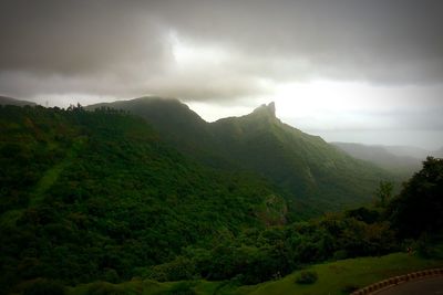 Scenic view of mountains against cloudy sky