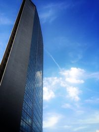 Low angle view of buildings against cloudy sky