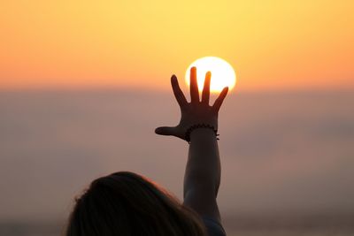 Silhouette of woman at sunset