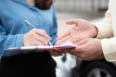 Midsection of man using mobile phone