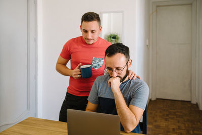 Two men looking at a laptop.
